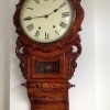 A wall mounted clock with chimes.