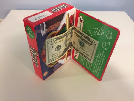 Money inside a M&M's Storybook.