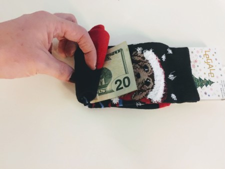 Rolling a $20 bill into a sock.