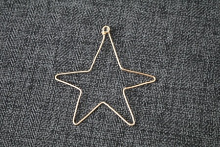 A bent wire ornament in the shape of a star.