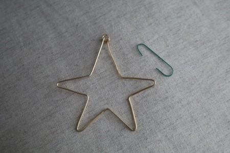 A bent wire ornament in the shape of a star.