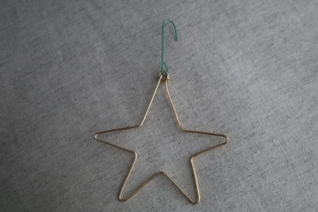 A bent wire ornament in the shape of a star.