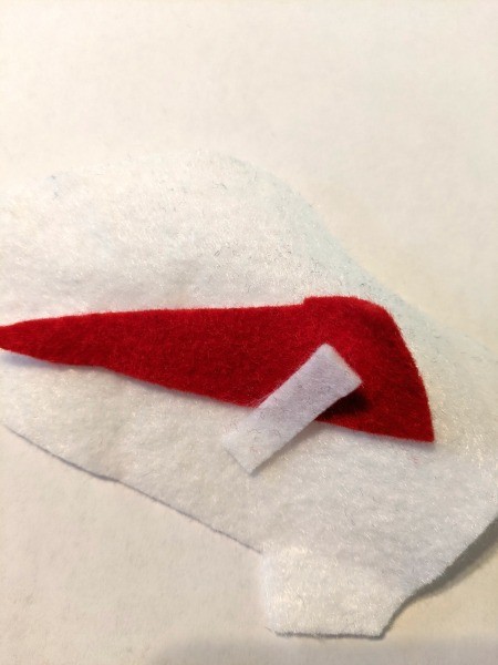 Christmas Dino Decoration - red and white felt pieces for the Santa hat