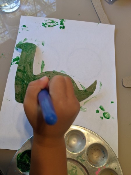 Christmas Dino Decoration - decorating the dino