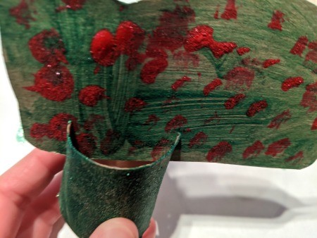 Christmas Dino Decoration - inserting dino body into the slits in the TP tubes