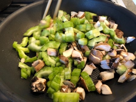 Cooking the vegetables in a frying pan.
