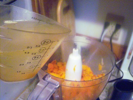 Adding broth to the food processor.