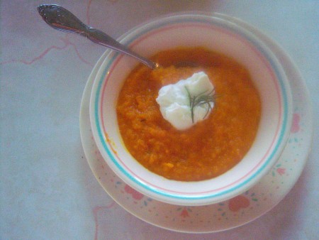 A bowl of butternut squash and carrot soup.