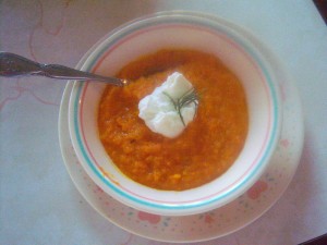 A bowl of butternut squash and carrot soup.