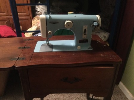 A blue vintage sewing machine.
