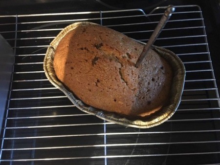 Checking the doneness of the pumpkin bread.