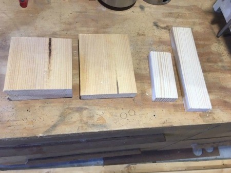 Several pieces of wood on a workbench.