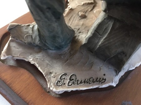 The signature on the base of a figurine.