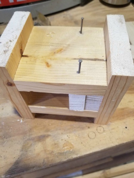 Attaching cut boards with nails.