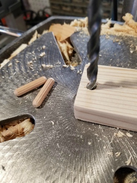 Drilling a hole in the end of a board.