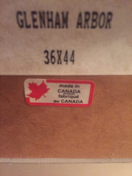 A label on the back of a framed picture.