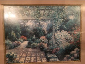 A framed picture of a garden.