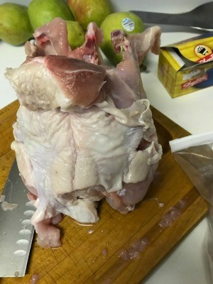 A turkey carcass being cut into smaller pieces.