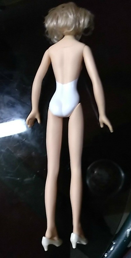 The back of an undressed doll.