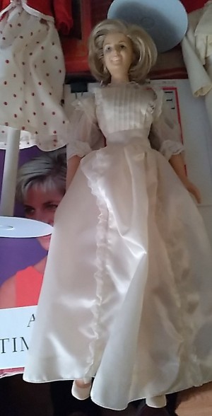 A doll wearing a white dress.