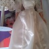 A doll wearing a white dress.
