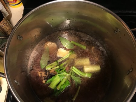 Adding the bay leaves and pepper to the mixture.