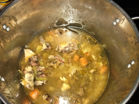 The cooked down bones and vegetables in broth.