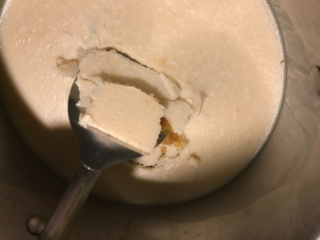 Lifting the fat off the broth.