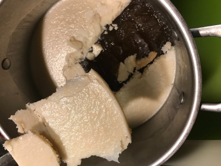 Lifting the fat off the broth.