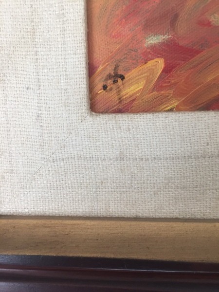 A marking in the corner of a painting.