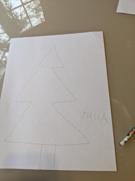 A Christmas tree shape on a piece of white paper.