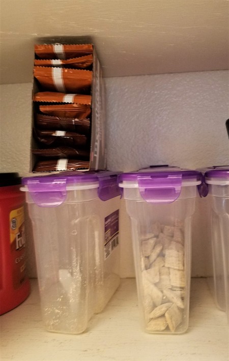 Storing the snacks in the pantry.