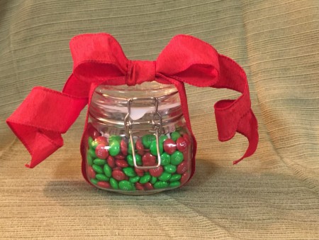 A candy jar with a red bow.