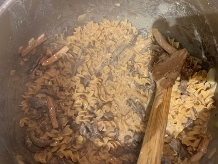 Adding the pasta to the mixture.