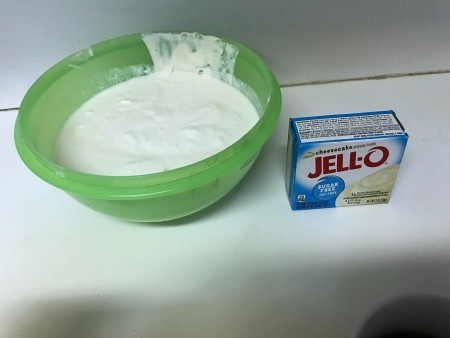 A bowl of homemade yogurt and a package of Jell-o pudding mix.