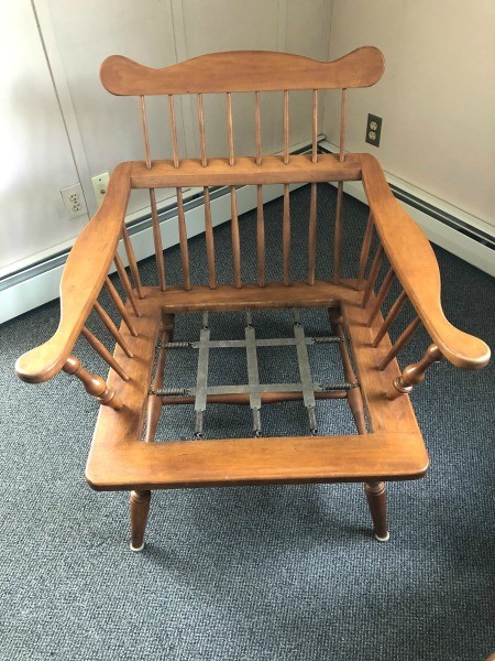 The wooden chair without a cushion.