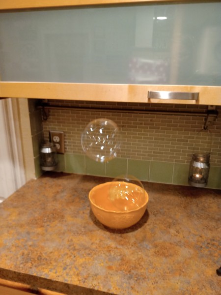 Big Soap Bubbles - large bubble floating over the bowl