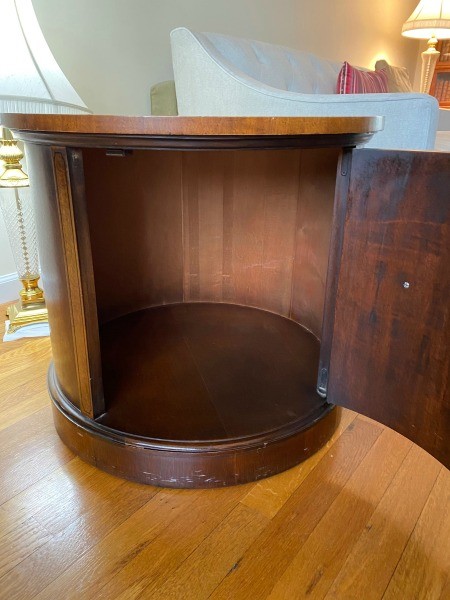 A round side table with a large cabinet.
