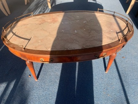 A coffee table with a metal border on the sides.