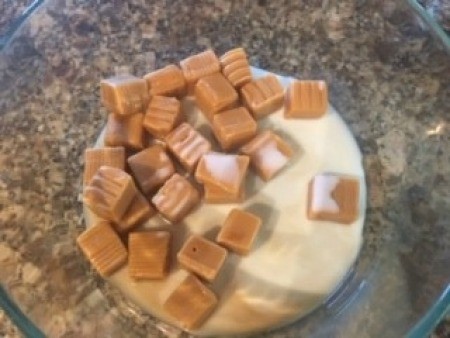 Adding the caramel and milk to a bowl.