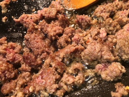 Cooking sausage in a pan.
