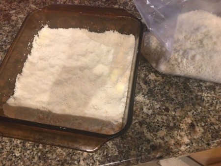 A pan with a crust mixture in the bottom.