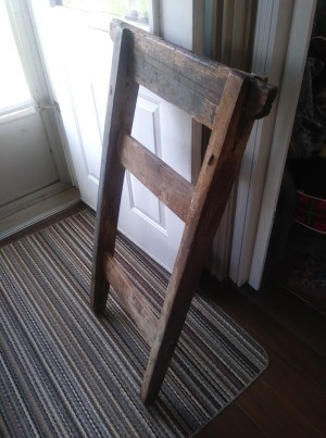 A wooden object inside, resembling a ladder or chair back.