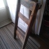 A wooden object inside, resembling a ladder or chair back.