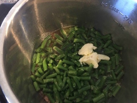 Green beans and other ingredients in an Instant Pot.