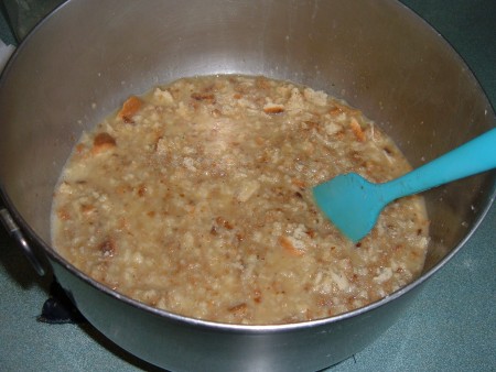 Adding the dressing to the mixing bowl.