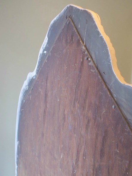 The back of the mirror on an antique vanity.