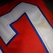 A yellow stain on the white number on a jersey.