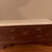A cedar chest with a padded seat.