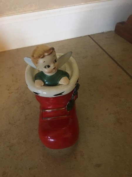 A figurine of a Christmas elf in a red boot.